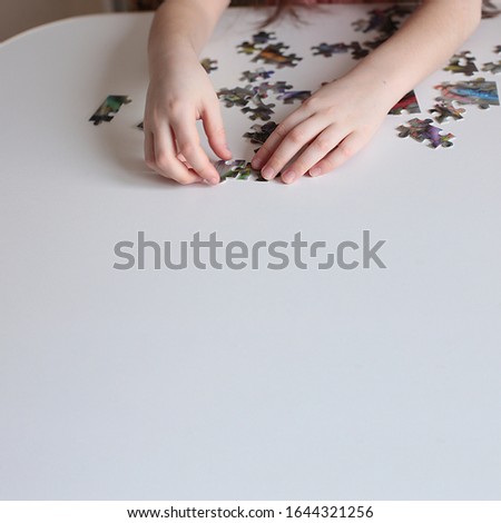 Similar – Baby Mädchen spielt mit Haarspangen, die auf dem Boden sitzen.