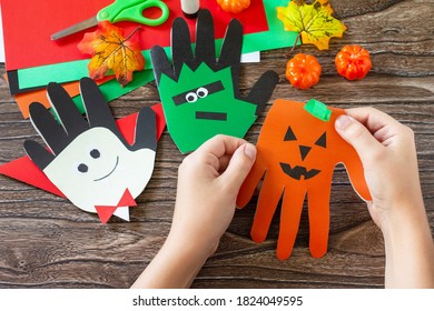 In The Hands Of A Child Greeting Card Halloween On Wooden Table. Children's Creativity Project, Crafts, Crafts For Kids.
