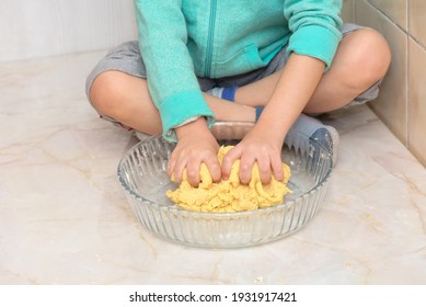 Hands Of A Child Kneading Dough