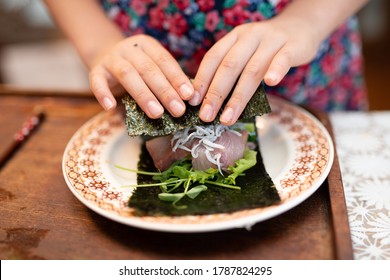 Hands Of A Child Making Sushi Rolls