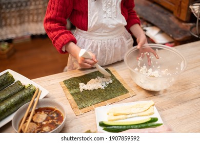 Hands Of A Child Making Sushi Rolls