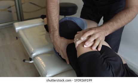 Hands of chiropractor working on female patient's back who lies facing sideways on stretcher. Osteopath appointment, treatment concepts - Powered by Shutterstock