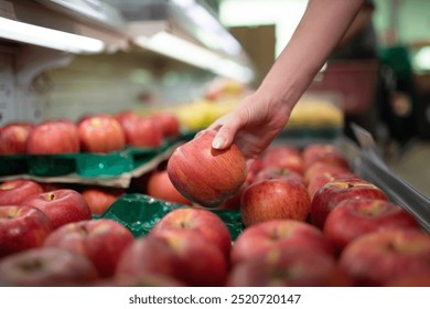 Hands choosing apples in a Japanese supermarket - Powered by Shutterstock