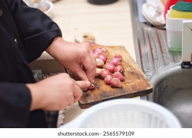 hands chopping shallots at kitchen 