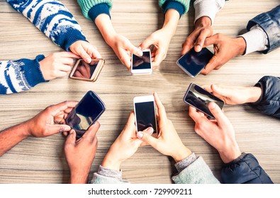 Hands Circle Using Phones On Table Top View - Multiracial People Holding Mobile Devices Sitting Around At Office Desk - Concept Of Friends Team Working And Modern Communication Technology Above Image 