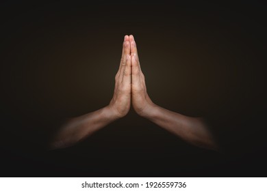 Hands clasped. Man hands in praying position on black background. Faith in religion and belief in God .