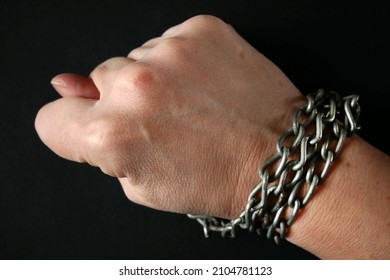 Hands Clenched Into Fists In Handcuffs In The Form Of Chains On A Black Background, The Problem Of Slavery And Violence Concept, Juneteenth Freedom Breaking Chains 