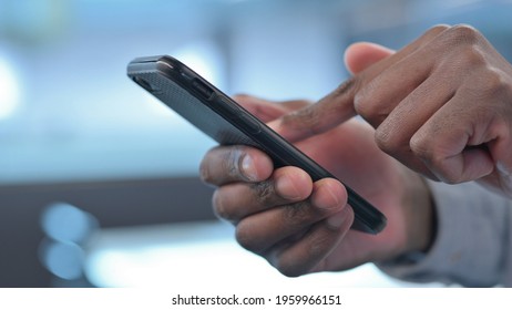 Hands Close up of African Man using Smartphone