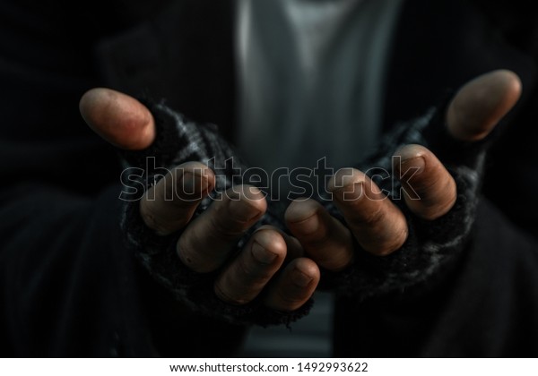 hands close up poor old man or\
beggar begging you for help sitting at dirty slum. Concept for\
poverty or hunger people,human Rights,donate and\
charity