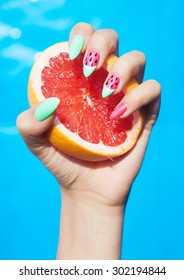 Hands Close Up Of Young Woman With Watermelon Manicure Holding Slice Of Grapefruit Summer Manicure Nail Art And Food Concept 