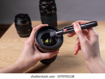 Hands Closeup Cleaning Digital Camera Lens With Professional Brush Tool, Removing Dust.