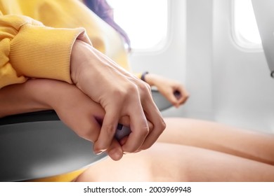 Hands Close-up In Front Of An Airplane Window, Fear Of Flying, The Cabin Of A Passenger Airliner. Aerophobia, Phobia, International Flights, Stress, Motion Sickness