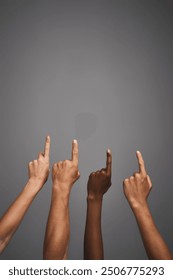 Hands, closeup and pointing up to direction in studio for deal, decision and vote isolated on gray background. Fingers, people and gesture for promo offer, ads and group show mockup space for choice