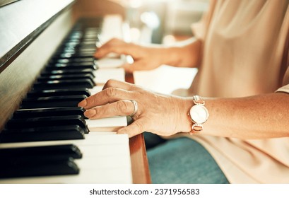 Hands, closeup and woman playing piano for music in living room for musical talent practice. Instrument, song and zoom of senior female person in retirement enjoying keyboard at modern home. - Shutterstock ID 2371956583