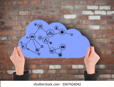 hands with cloud and application icons on it in front of a brick wall