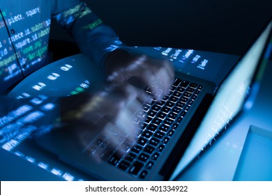 Hands of coder typing very fast, blurred motion