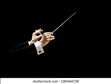 Hands of conductor on a black background 