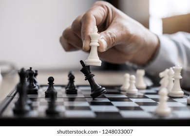 Hands Of Confident Businessman Colleagues Playing Chess Game To Development Analysis New Strategy Plan, Leader And Teamwork Concept For Win And Success.