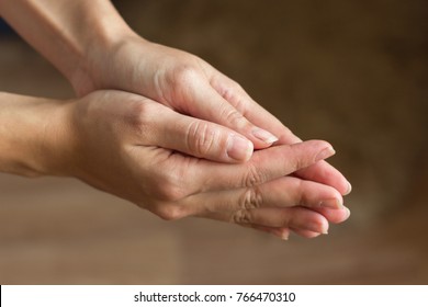 Hands are connected close-up. A gesture of help, supplication, repentance.