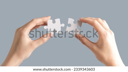 Hands connecting puzzle pieces. Connection, mental health, match concept.