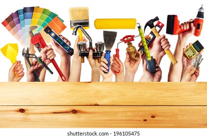 Hands with construction tools. House renovation background.