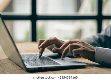 Hands of contemporary young office manager on laptop keyboard during working, surfing net, shopping online or online job. close up pictures - Shutterstock ID 2354314165