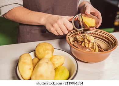 Hands Of Cook Cut Peel Of Raw Potatoes With Kitchen Knife For Peeling Vegetables, Peeler, Put Food Waste In Separate Container For Further Processing. Zero Waste, Using Organic Waste For Compost