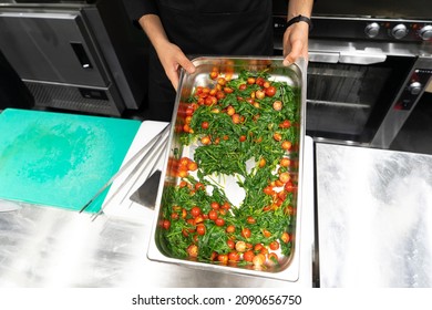 The Hands Of The Cook Making Green Italian Salad With Tomatos And Olive Oil  In Metall Dish On The Resturant Kitchen