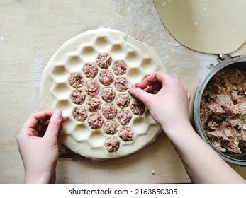 The Hands Of The Cook Spread The Minced Meat On The Dumplings. The Process Of Making Dumplings. Girl Cooks For Her Family. Home Cooking, Cooking At Home. Selective Focus, Soft Light, Copy Space