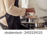 Hands, cooking and pot with steam in the home for lunch or dinner, busy and hungry for food with preparation. Catering, Person with chopsticks for Asian cuisine and meal with nutrition in kitchen