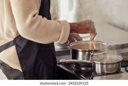 Hands, cooking and pot with steam in the home for lunch or dinner, busy and hungry for food with preparation. Catering, Person with chopsticks for Asian cuisine and meal with nutrition in kitchen