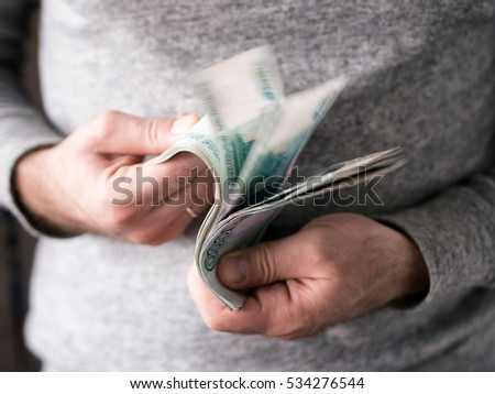 Hands counting russian rubles. Selective focus