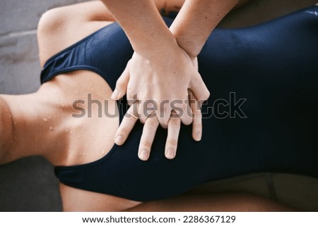 Hands, cpr and first aid with help of lifeguard for emergency, drown or accident after swimming. Sports, breathing and resuscitation of woman, rescue of athlete or saving life of swimmer in top view.