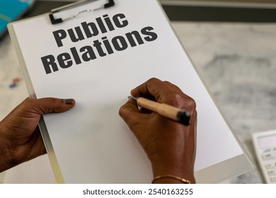 Hands crafting a PR plan on a clipboard. Ready for your message! - Powered by Shutterstock