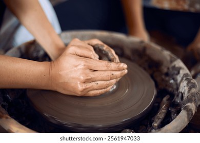 Hands of craftsman artist working on pottery wheel.Selective Focus - Powered by Shutterstock