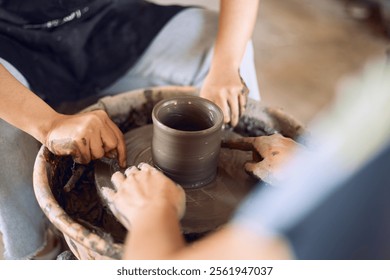 Hands of craftsman artist working on pottery wheel.Selective Focus - Powered by Shutterstock