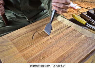 hands of the craftsman carve  with a chisel