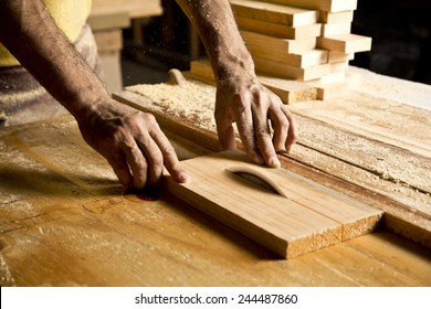 Hands Of The Craftsman Cut A Piece Of Wood