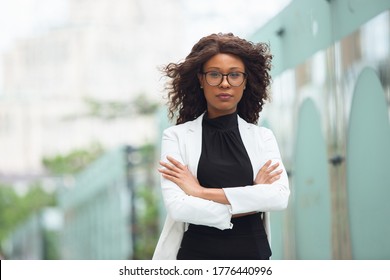 Hands crossed. African-american businesswoman in office attire smiling, looks confident and serious, busy. Finance, business, equality and human rights concept. Beautiful young model, successful.