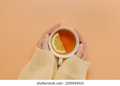 Hands with cup of tea with lemon, top view, flat lay. - Powered by Shutterstock