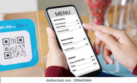 Hand's Customer Scan QR Code For Online Menu Service At Table In Restaurant During Pandemic Coronavirus. New Normal Contactless Technology Lifestyle Protection Coronavirus Pandemic In Restaurant