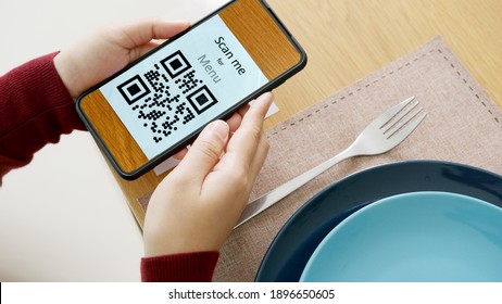 Hand's Customer Scan QR Code For Online Menu Service At Table In Restaurant During Pandemic Coronavirus. New Normal Contactless Technology Lifestyle Protection Coronavirus Pandemic In Restaurant