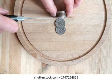 Hands cut dollar coins with a knife, separating them like pieces of food. Concept of taxes, fraud or profit. Top view. - Powered by Shutterstock