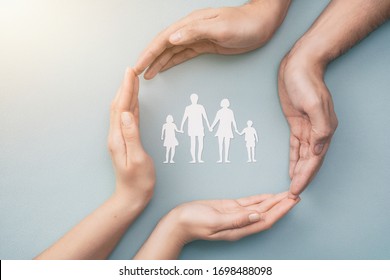 Hands with cut out paper silhouette on table. Family care concept. - Shutterstock ID 1698488098