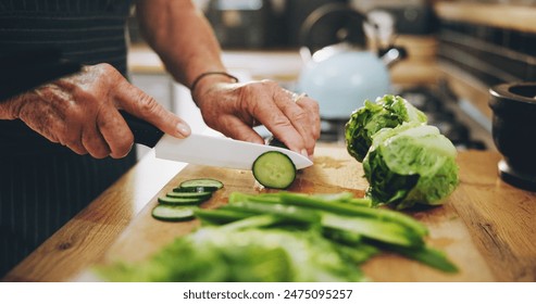 Hands, cutting board and salad in kitchen with green vegetables for healthy food or nutrition. Person with culinary skills for cooking lunch with lettuce, cucumber and organic ingredients at home