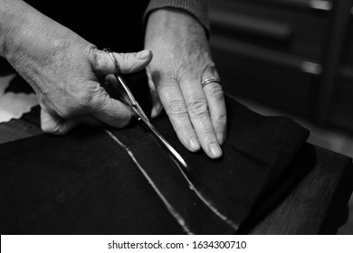 Hands cutting material with scissors