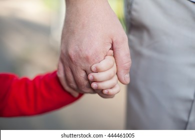 hands of dad and daughter