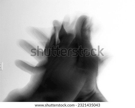 Long exposure of a woman’s hand at night. Waving hand that wants to say, what a pity that you stop here