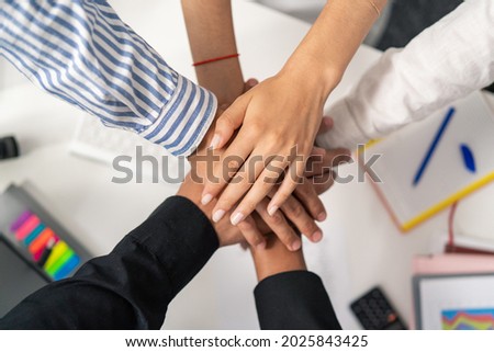 Hands of different nationalities, different skin colors, placed on top of each other, one on top of the other, intertwined, an agreement, a close-knit team, working together, a bet, all for one