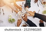 Hands, dinner and toast champagne at party for celebration, goals and above for success with team at night. Business people, drinks and alcohol with cheers, congratulations and new year at gala event